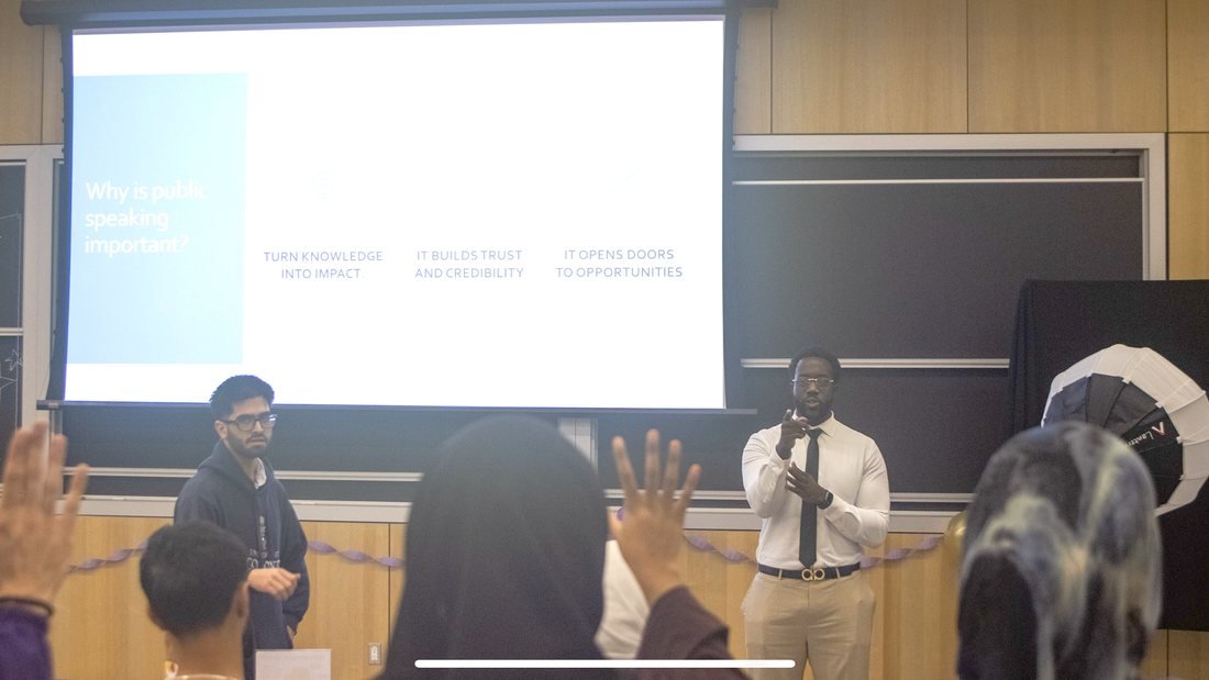 Ezekiel K. Bissah leading the Public Speaking in the World of Research workshop, with attendees raising their hands